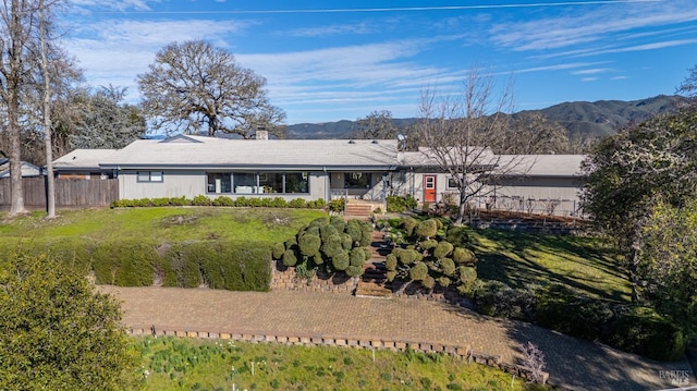 back of property with a mountain view