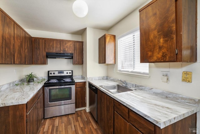 kitchen featuring stainless steel appliances, sink, and dark hardwood / wood-style flooring