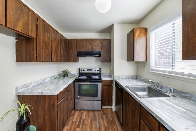 kitchen with sink, ventilation hood, stainless steel appliances, and dark hardwood / wood-style floors