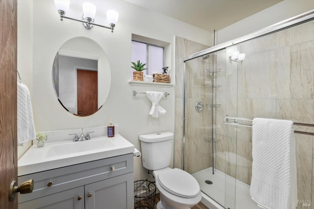 bathroom featuring vanity, toilet, and walk in shower