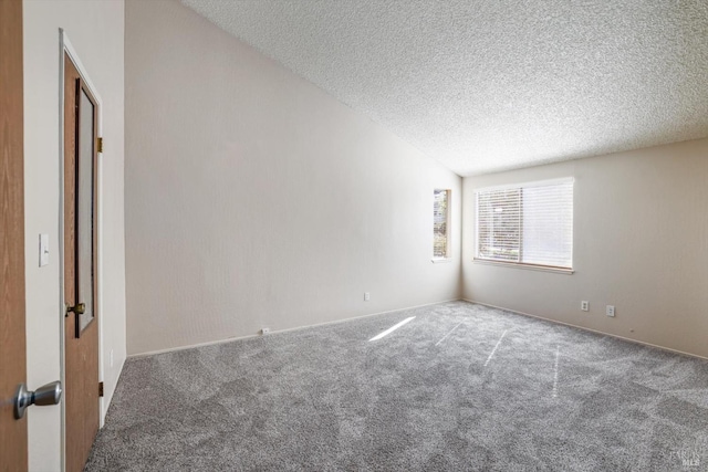 carpeted spare room with a textured ceiling