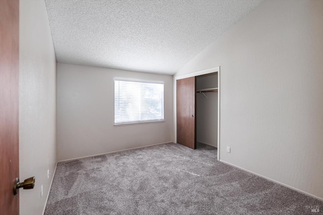 unfurnished bedroom with a closet, carpet floors, and a textured ceiling