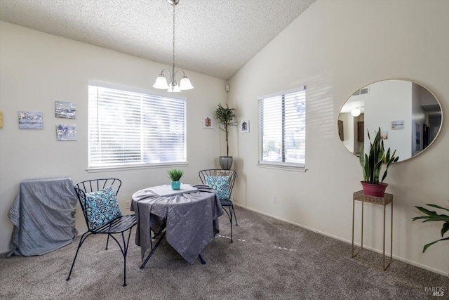 dining area featuring lofted ceiling, a textured ceiling, carpet floors, and an inviting chandelier