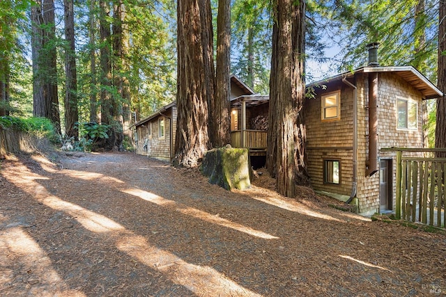 view of side of property featuring a wooden deck