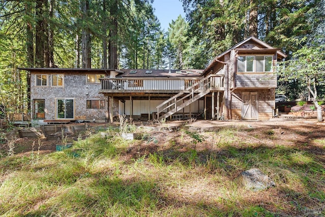 rear view of house featuring a wooden deck