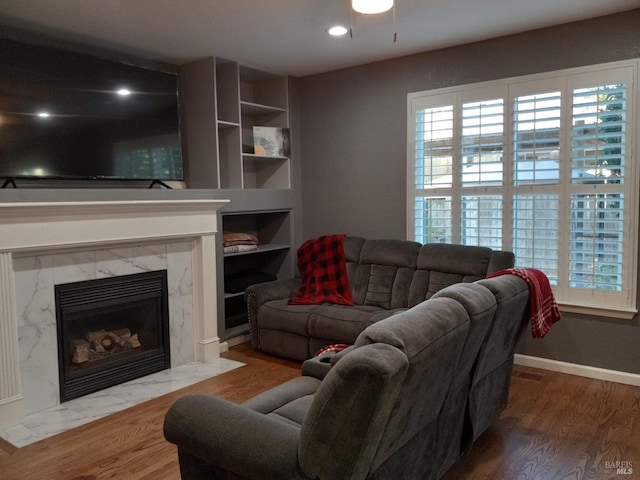 living room featuring hardwood / wood-style flooring and a high end fireplace