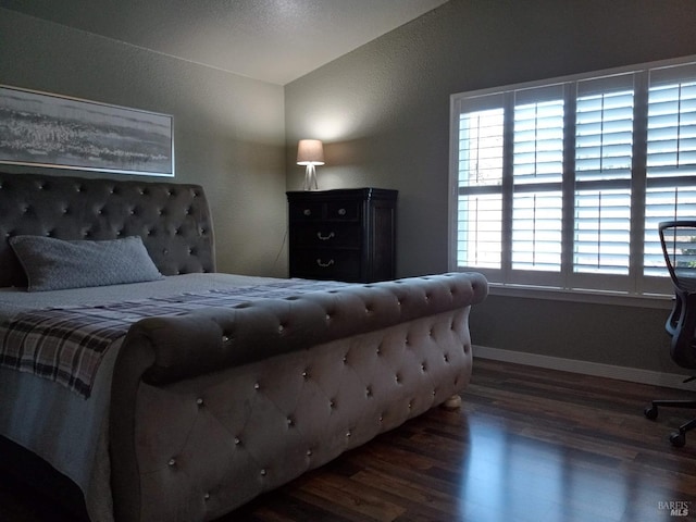 bedroom with dark hardwood / wood-style flooring