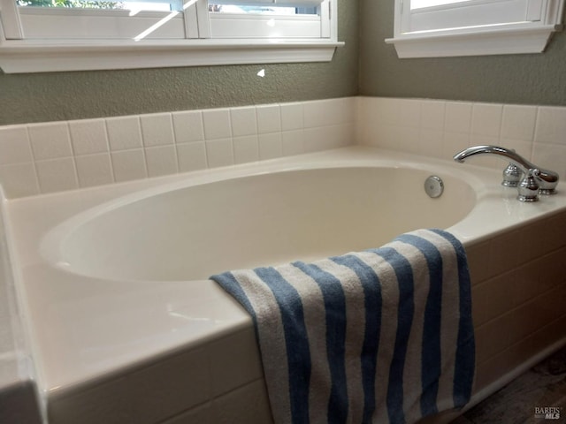 bathroom with tiled bath