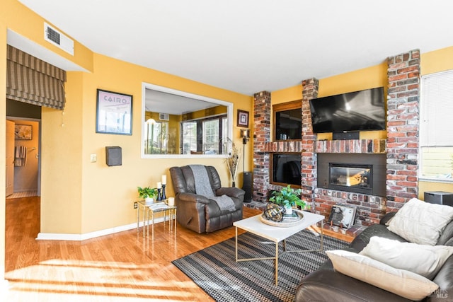 living room featuring hardwood / wood-style floors, a healthy amount of sunlight, and a fireplace