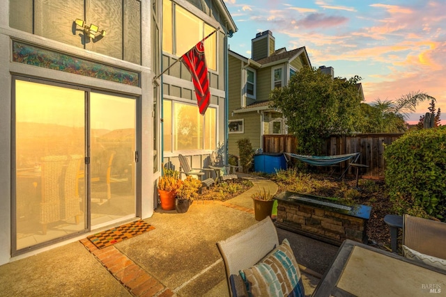 view of patio terrace at dusk