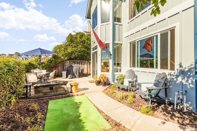 view of patio featuring area for grilling and fence