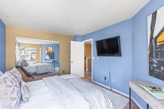 bedroom featuring baseboards and a closet