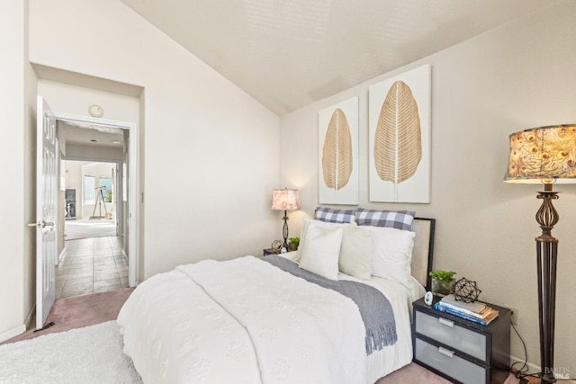 carpeted bedroom with lofted ceiling