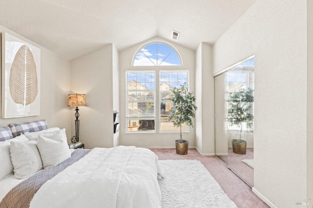 carpeted bedroom featuring vaulted ceiling