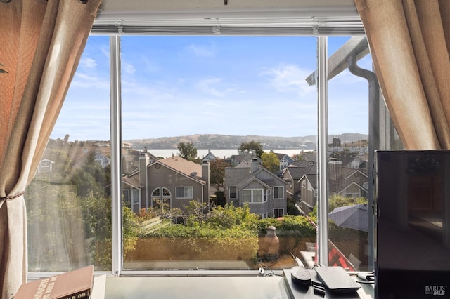 doorway to outside with a healthy amount of sunlight and a residential view