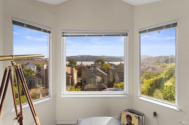 sunroom / solarium with plenty of natural light and a residential view