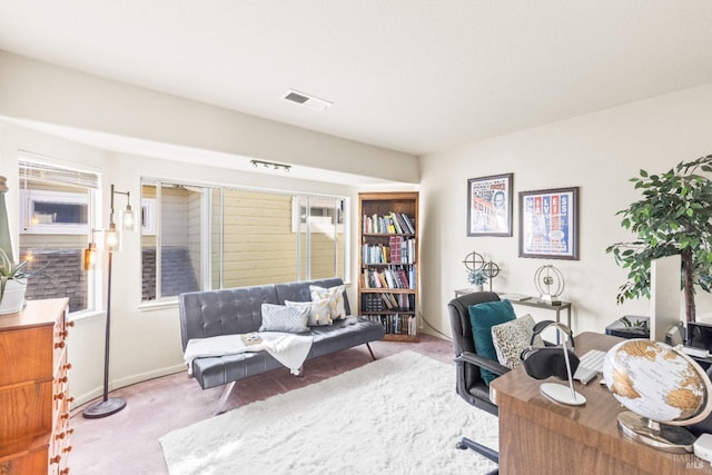 carpeted office space with visible vents and baseboards