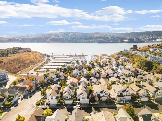 birds eye view of property with a water and mountain view