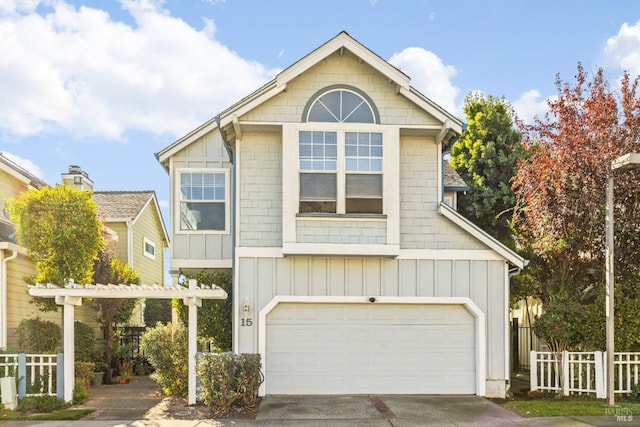 view of front of home featuring board and batten siding, fence, driveway, an attached garage, and a pergola