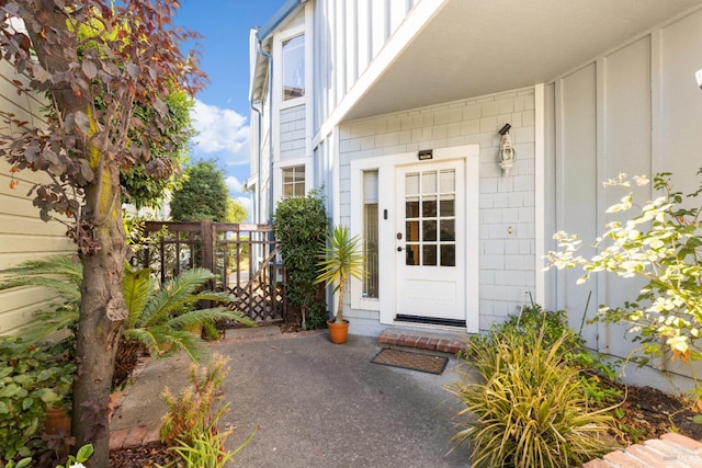 doorway to property featuring fence