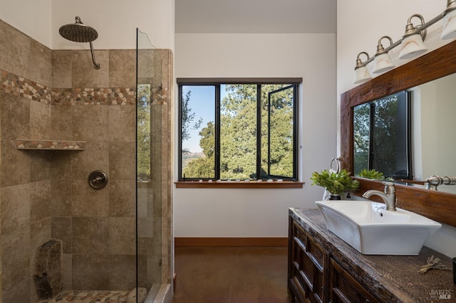 bathroom featuring a tile shower and vanity