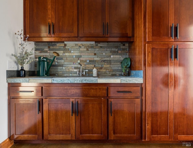 bar featuring decorative backsplash and sink