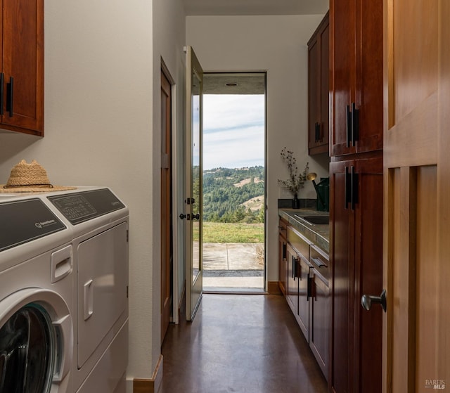 laundry area featuring independent washer and dryer and cabinets