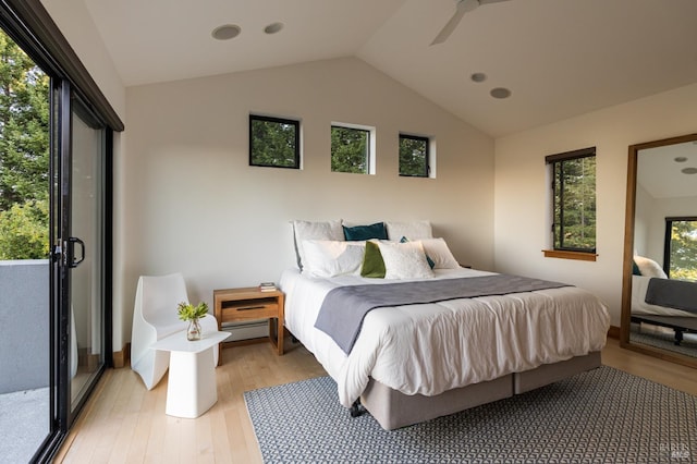 bedroom featuring vaulted ceiling, a baseboard heating unit, light hardwood / wood-style floors, and ceiling fan