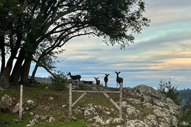 nature at dusk featuring a mountain view and a rural view