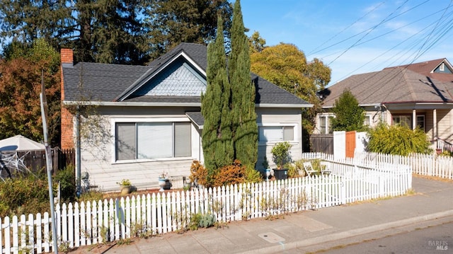 705 Tupper St, Santa Rosa, CA 95404 - view of front facade featuring a fenced front yard, a chimney, and a shingled roof