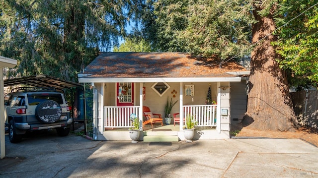 view of front of house with a carport and a porch