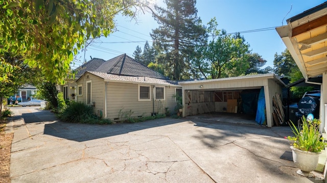 view of side of property featuring a garage and an outbuilding