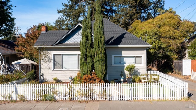 705 Tupper St, Santa Rosa, CA 95404 - view of front of house with a fenced front yard, a chimney, and a shingled roof