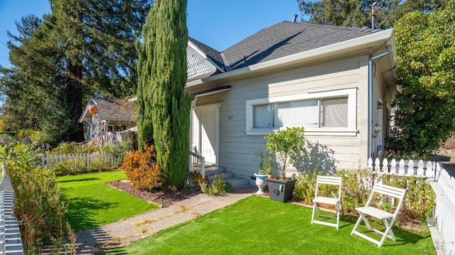 rear view of house with a yard