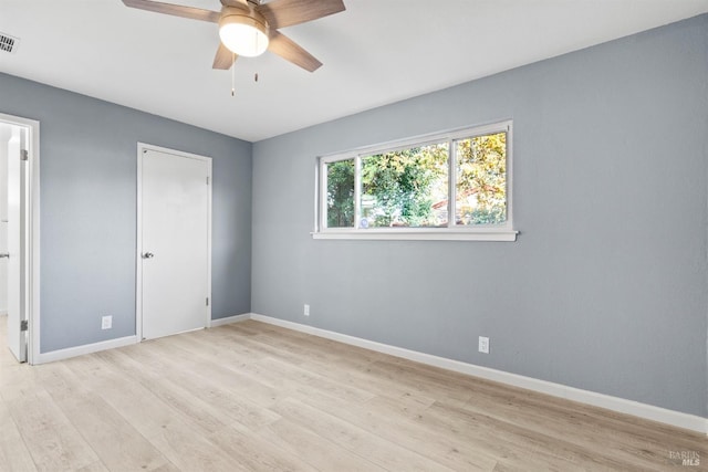 empty room featuring ceiling fan and light hardwood / wood-style floors