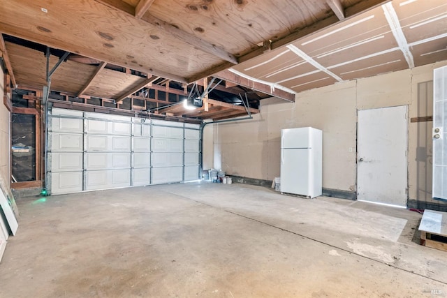 garage featuring a garage door opener and white refrigerator