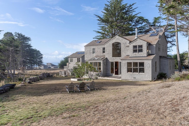 back of property with a patio and a lawn