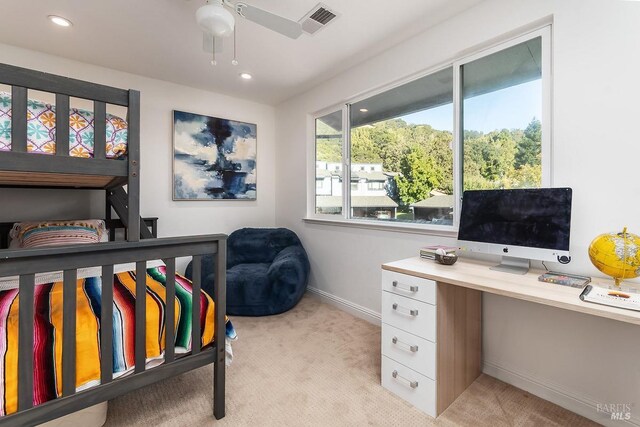 bedroom featuring light colored carpet and ceiling fan