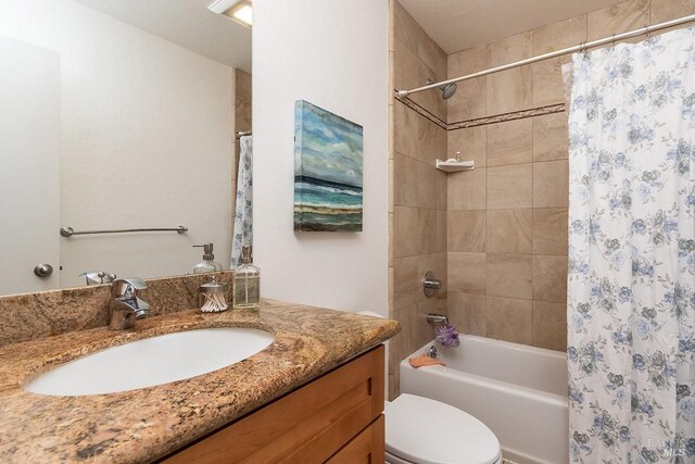 full bathroom with vanity, toilet, and shower / bath combo with shower curtain