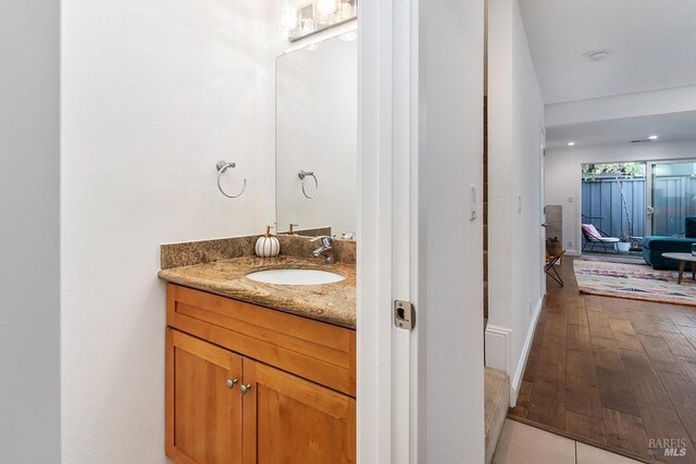 bathroom with vanity and hardwood / wood-style flooring