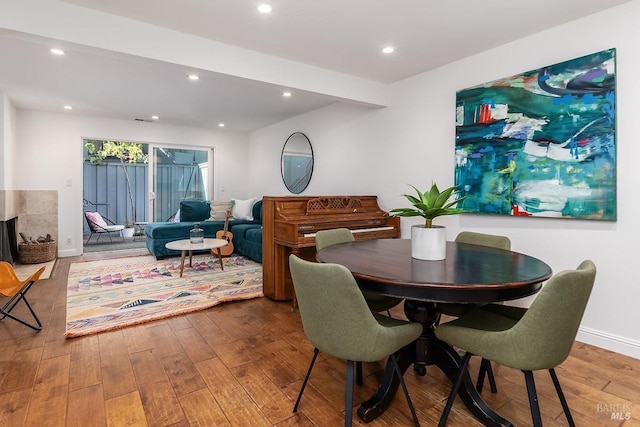 dining room with baseboards, recessed lighting, and hardwood / wood-style flooring