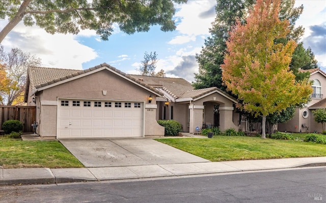 ranch-style house with a garage and a front lawn