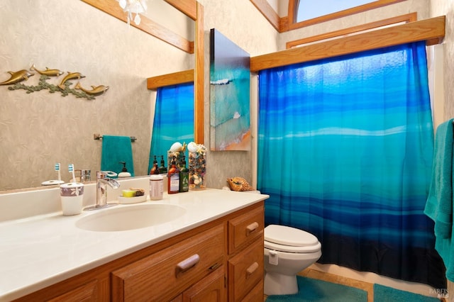 bathroom featuring vanity, toilet, and a shower with shower curtain