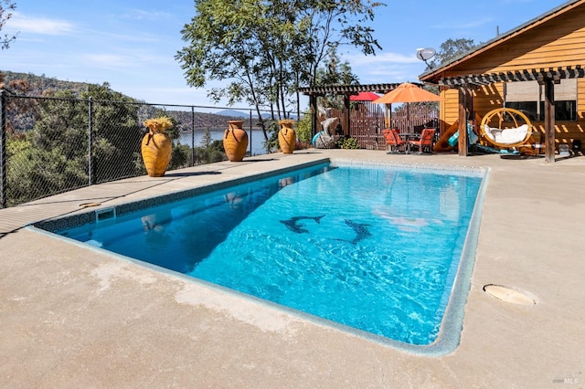 view of pool with a pergola and a patio