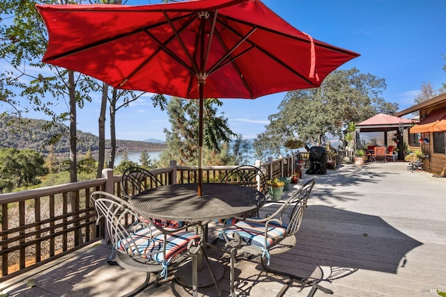 wooden deck with a gazebo and a mountain view