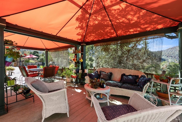 wooden deck with a gazebo and a mountain view