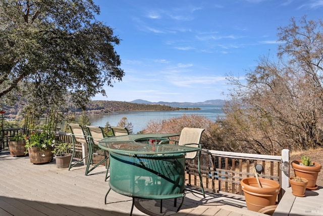 deck with a water and mountain view