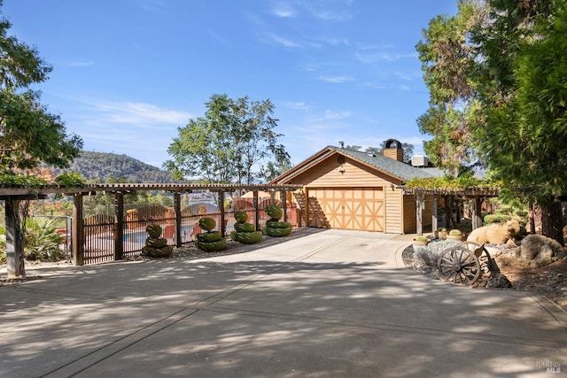 view of front facade featuring a garage and a mountain view