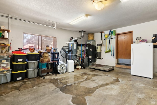 garage featuring water heater and white fridge