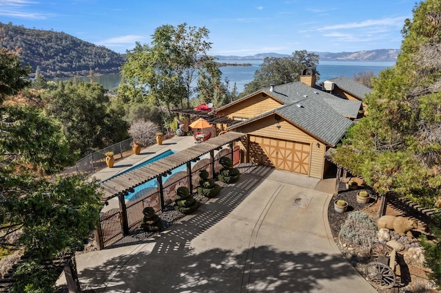 birds eye view of property featuring a water and mountain view